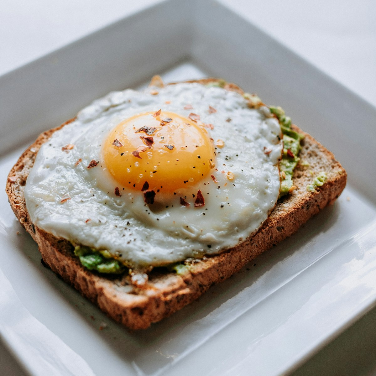 Flat white, pistachio morning bun, and egg toast at Lucy's